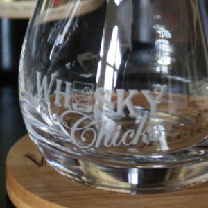 Closeup of Glencairn Mixer Glass with etched whisky chicks logo