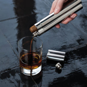 cigar flask pouring whiskey into glass